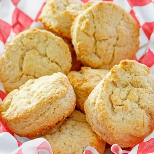 copycat KFC buttermilk biscuits in a parchment-lined basket.