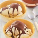 two bowls of vanilla ice cream topped with homemade chocolate magic shell.