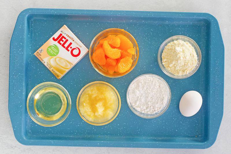 mandarin orange cake ingredients on a tray.