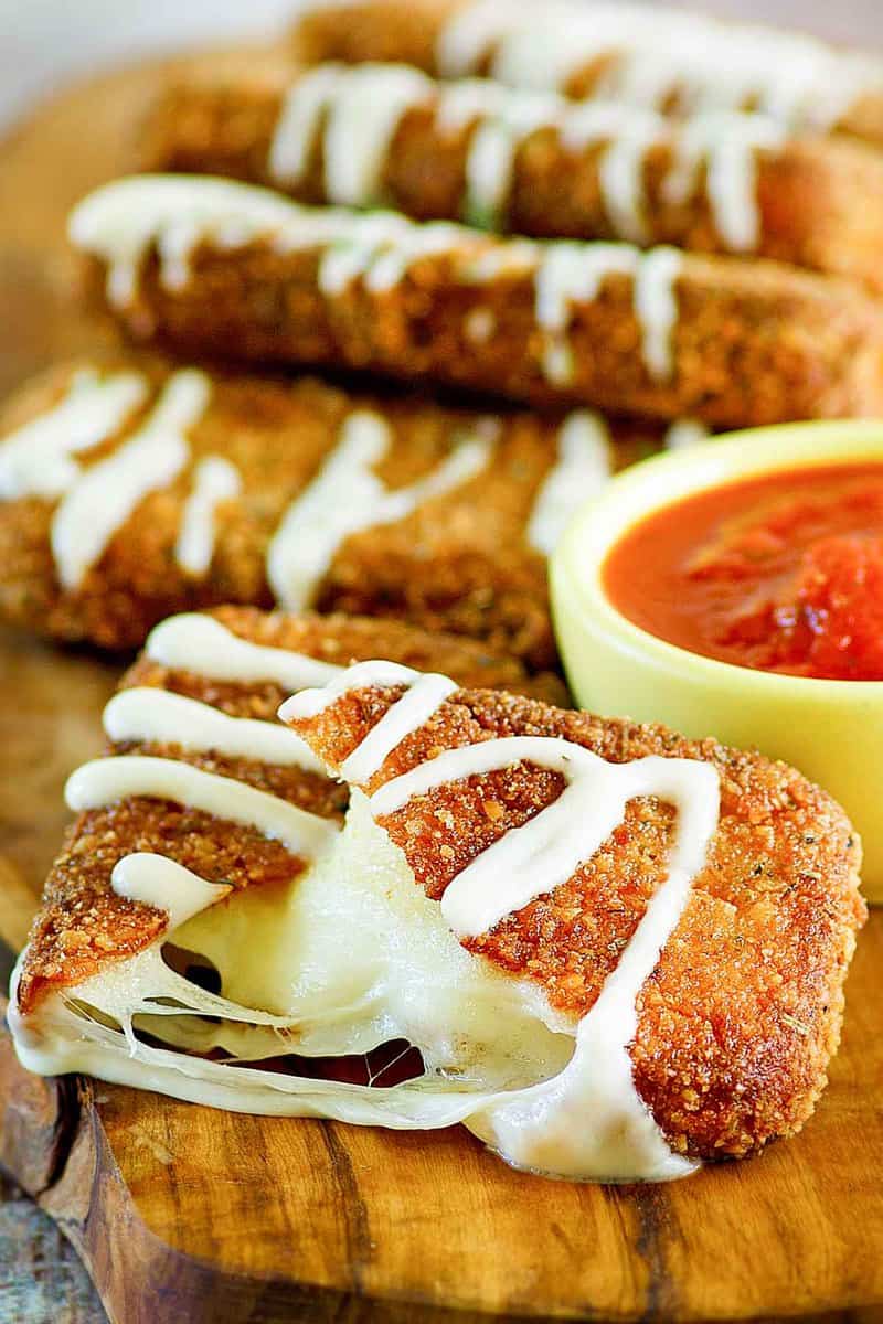 copycat Olive Garden Fried Mozzarella Sticks on a wood board.