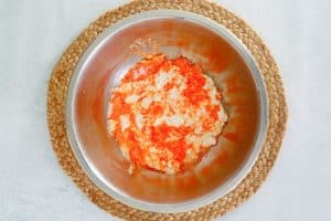 orange jello and cottage cheese mixture in a bowl.