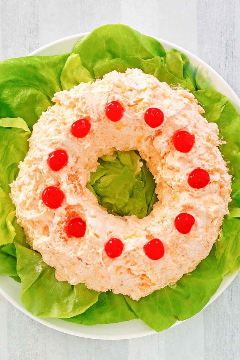 overhead view of orange fluff jello salad on a platter.