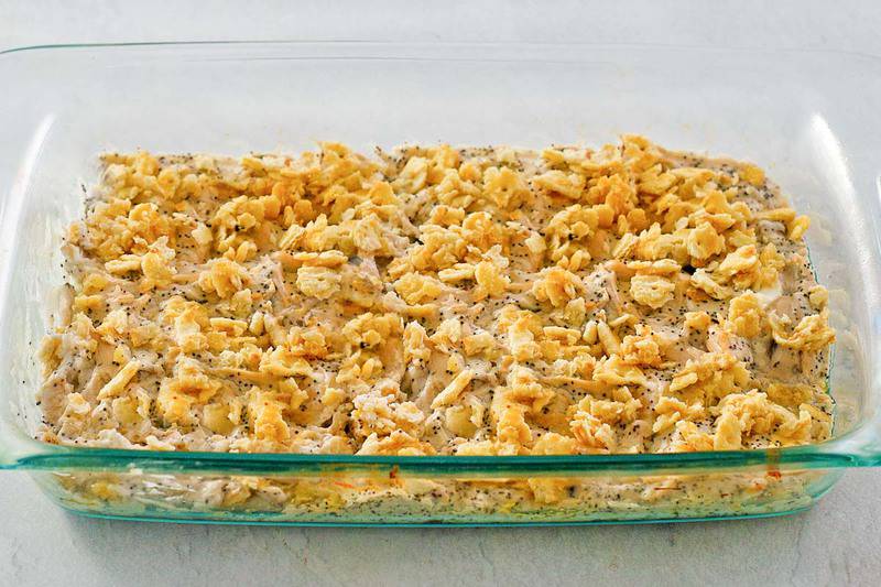 poppy seed chicken with cracker topping in a baking dish.