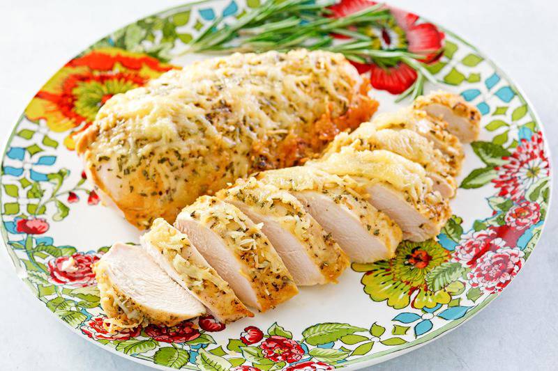 rosemary chicken with parmesan cheese on a plate.