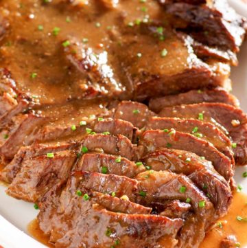to die for beef roast and gravy on a platter.