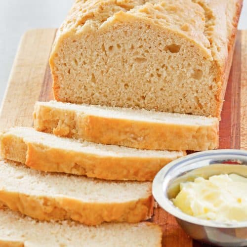 beer bread and butter on a cutting board.