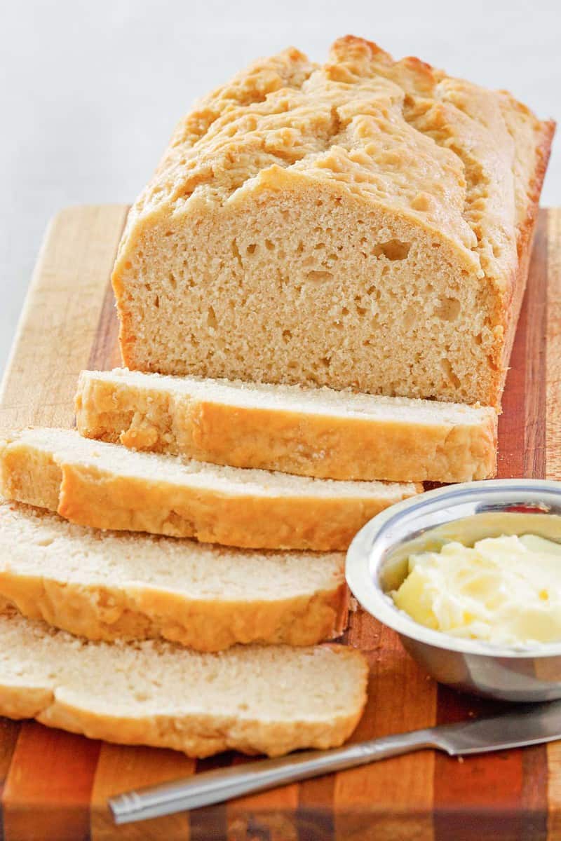 beer bread and butter on a cutting board.