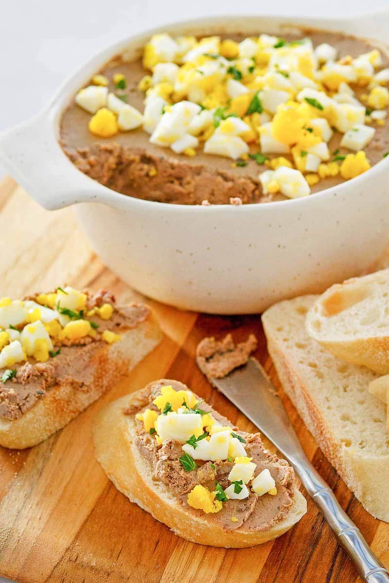 chicken liver pate in a dish and on bread slices.