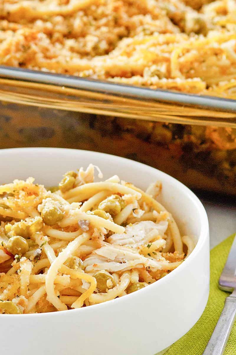 chicken tetrazzini in a white bowl and glass baking dish.