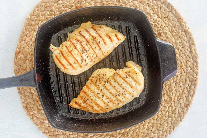 grilled margarita chicken breasts in a cast iron grill pan.