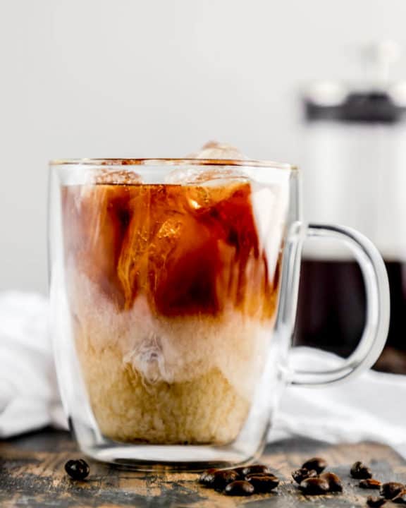 cup of iced cold brew coffee with cream.