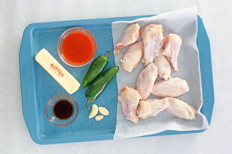 grilled buffalo wings ingredients on a tray.