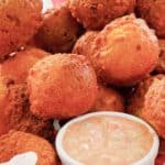 homemade hush puppies and a cup of remoulade sauce.