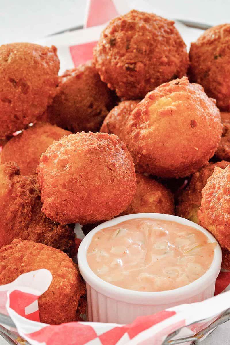 homemade hush puppies and a cupful  of remoulade sauce.