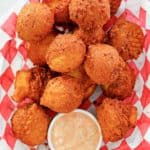 overhead view of homemade hush puppies in a basket.