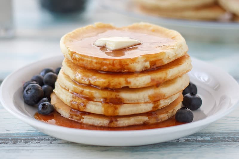 homemade IHOP buttermilk pancakes with syrup on a plate.