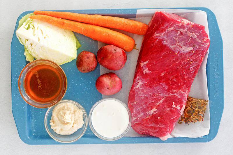 instant pot corned beef and cabbage ingredients on a tray.