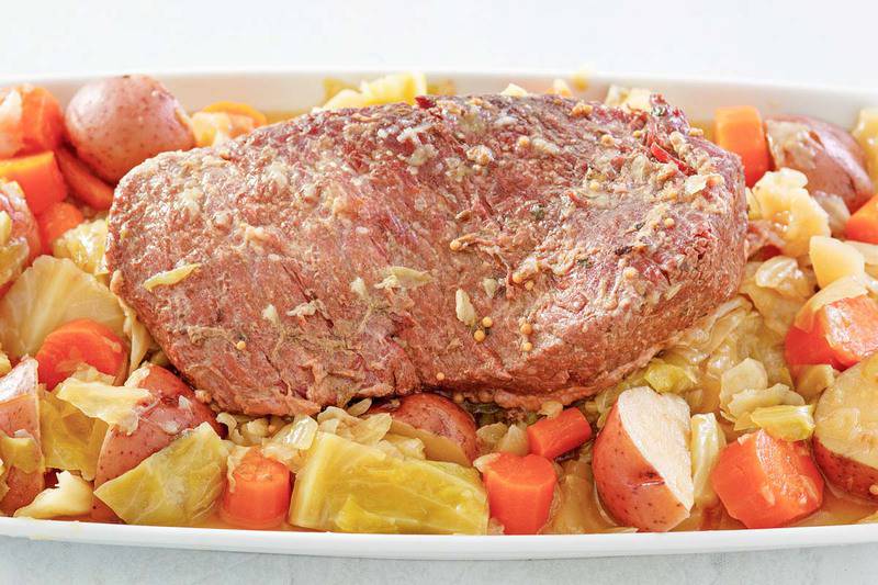 instant pot corned beef and cabbage on top of cabbage, carrots, and potatoes.
