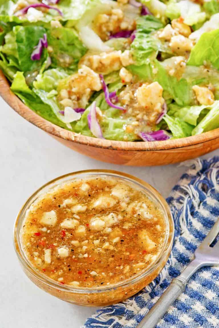 homemade Outback blue cheese vinaigrette dressing in a small bowl and on a salad.