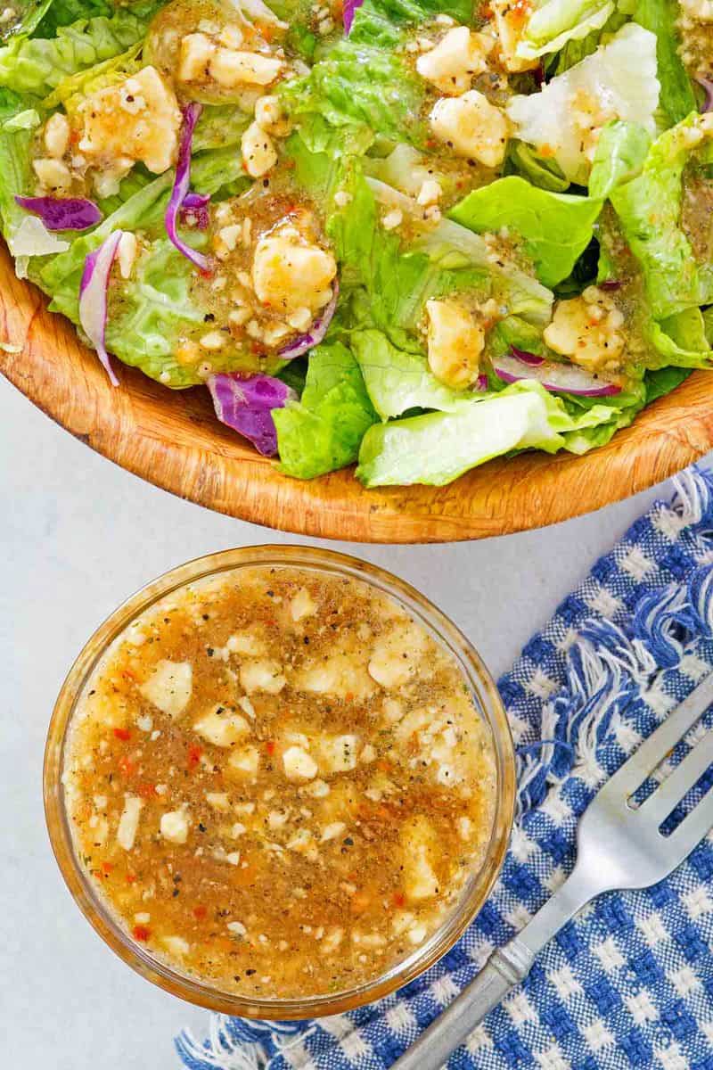 overhead view of copycat Outback blue cheese vinaigrette in a bowl and a salad.