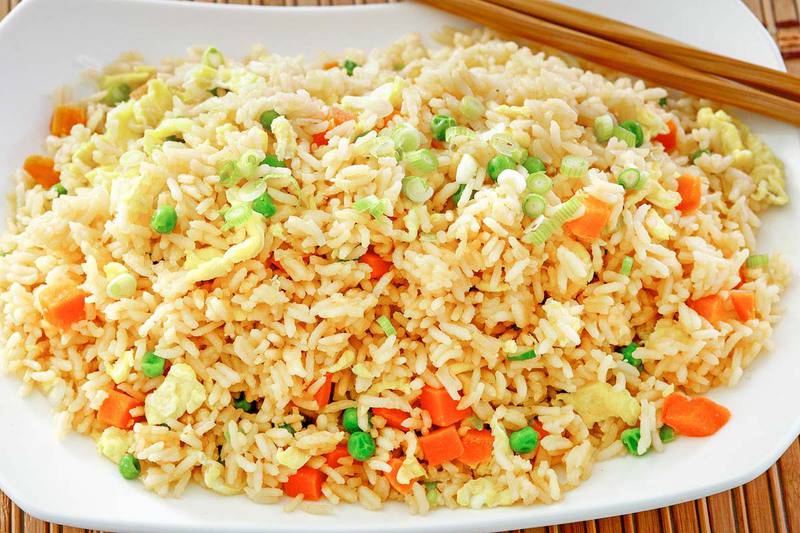 homemade Panda Express fried rice and chopsticks on a plate.