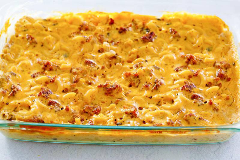 sausage mac and cheese casserole in a baking dish.