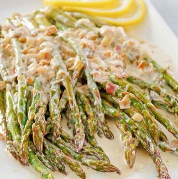 sauteed asparagus with lemon cream sauce on a platter.