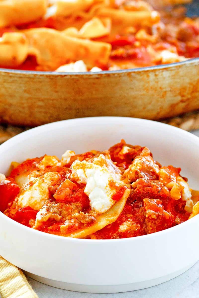 skillet lasagna in a bowl in front of the skillet.