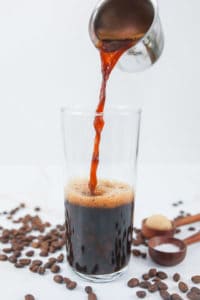 pouring espresso into a glass.