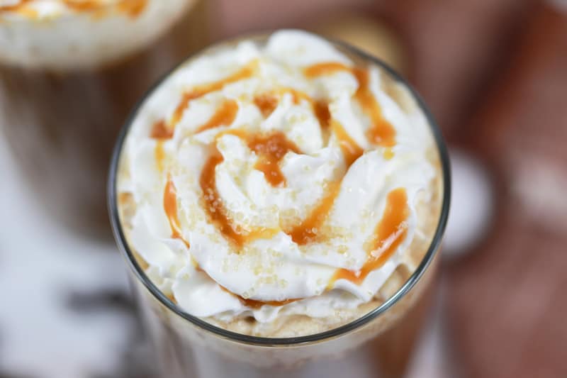 top of a homemade Starbucks salted caramel latte with whipped cream and caramel drizzle.