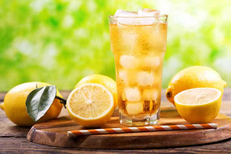 a glass of sweet iced tea and lemons.