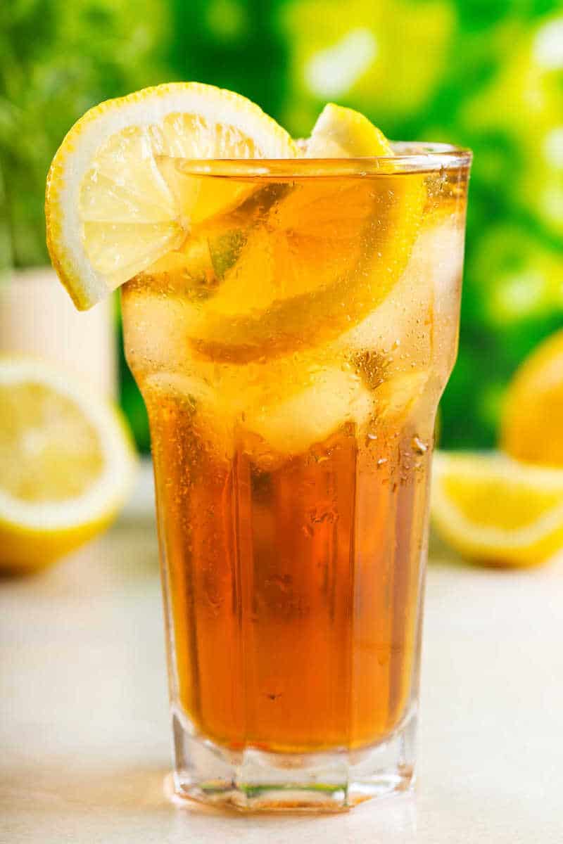 a glass of sweet iced tea with lemon.