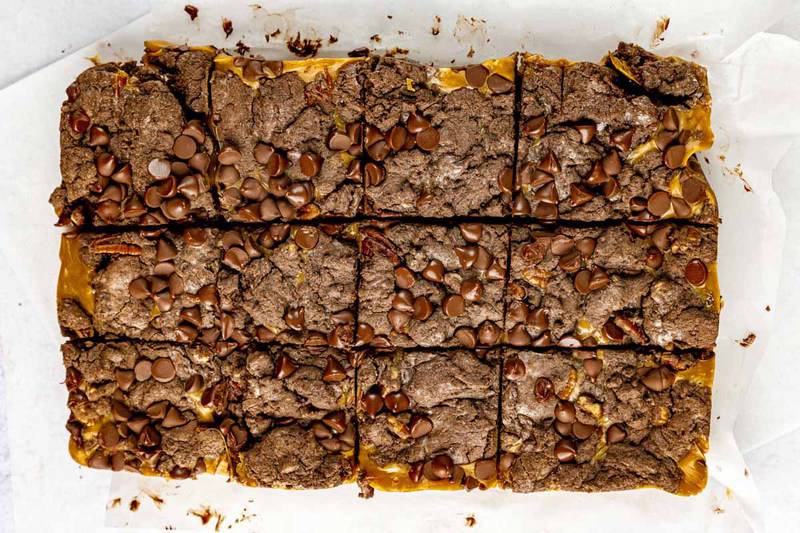overhead view of a batch of turtle brownies sliced into squares.