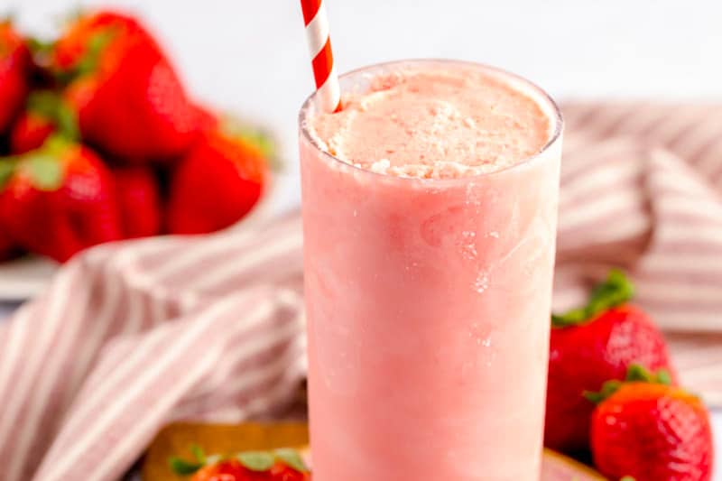 homemade Wendy's strawberry frosty in a glass with a straw.