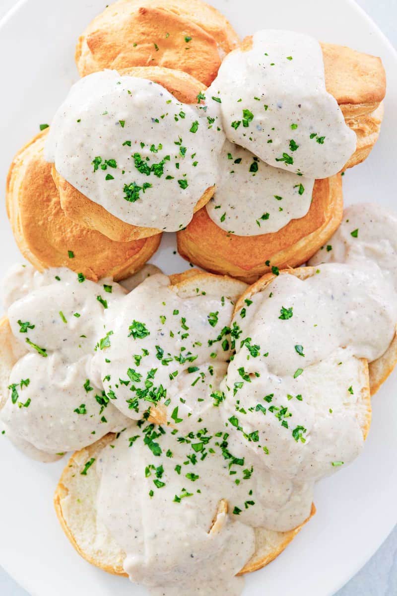overhead view of white gravy over biscuits.