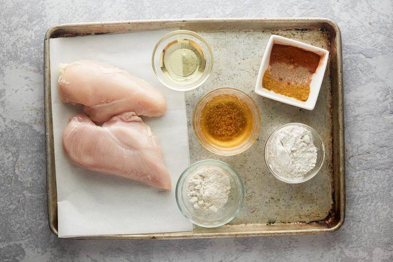 beer battered chicken ingredients on a baking sheet.