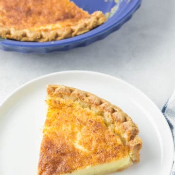 buttermilk pie slice on a plate next to the pie.