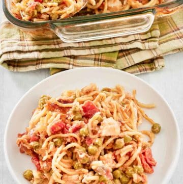 chicken spaghetti casserole on a plate and glass baking dish.