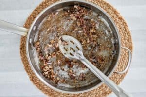 cooking flour, bacon, onion, and garlic in a pot.