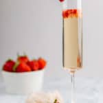 copycat Grand Lux Cafe Strawberry Bellini garnished with a strawberry.