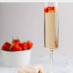 copycat Grand Lux Cafe Strawberry Bellini and fresh strawberries in a bowl.