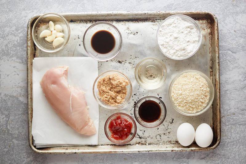 ingredients for katsu chicken on a baking sheet.