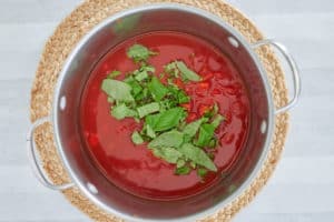 tomato basil soup ingredients in a pot.