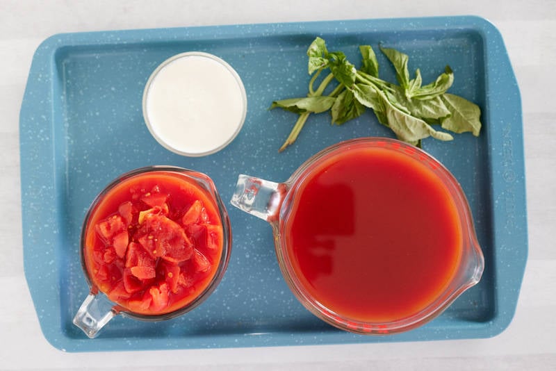 La Madeleine tomato basil soup ingredients on a tray.