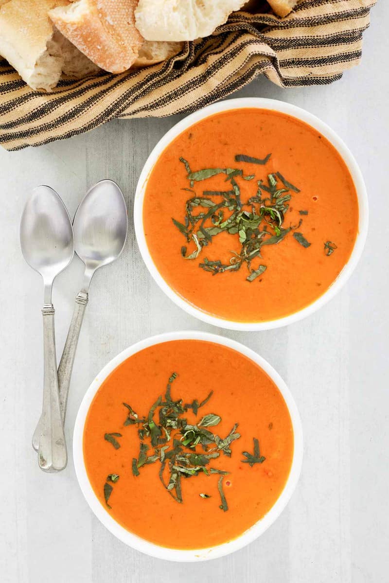 overhead view of copycat La Madeleine tomato basil soup in two bowls.