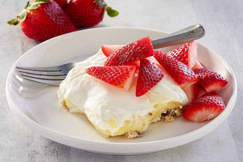 lemon lush dessert and a fork on a plate.