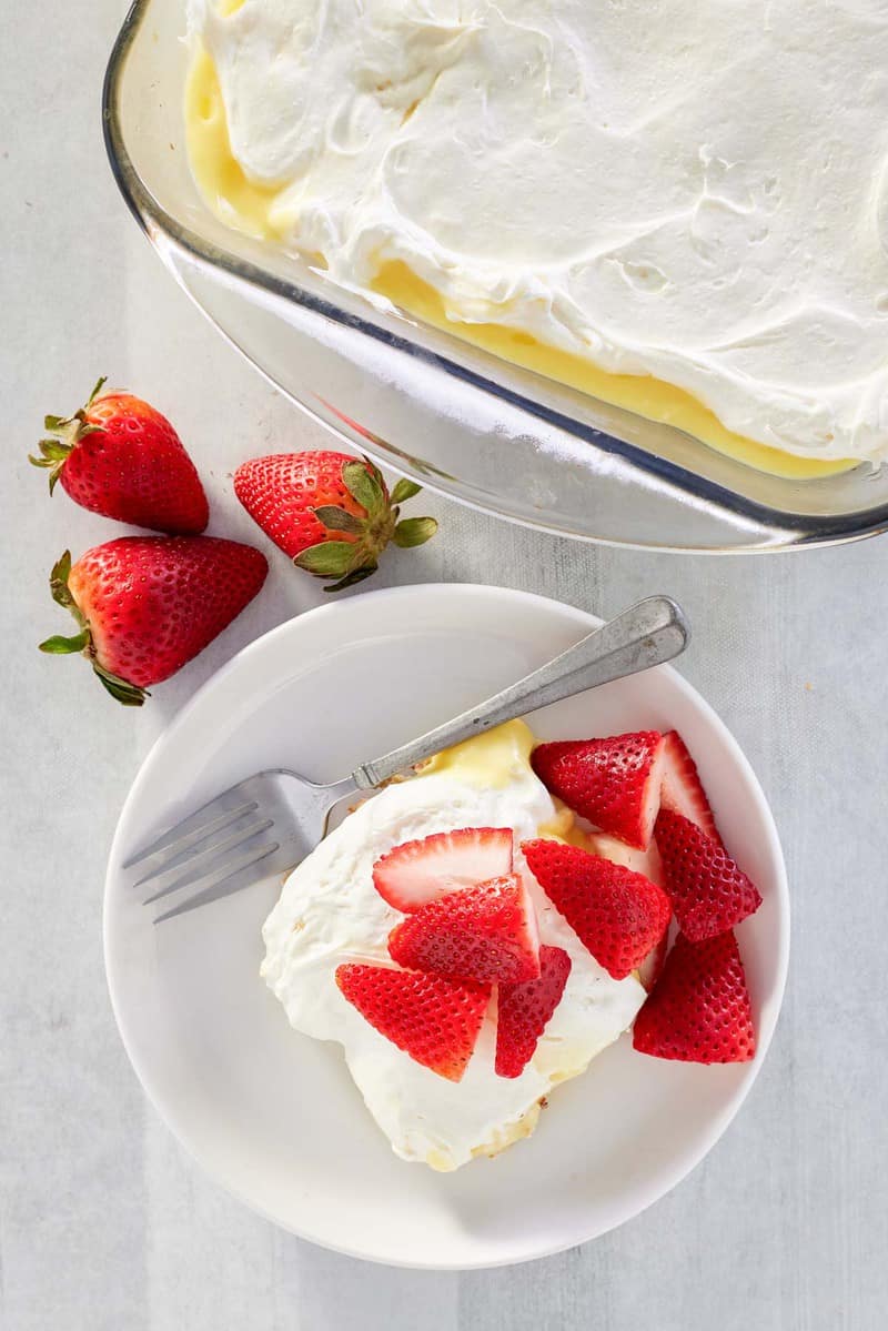 overhead view of lemon lush dessert in a dish and on a plate.