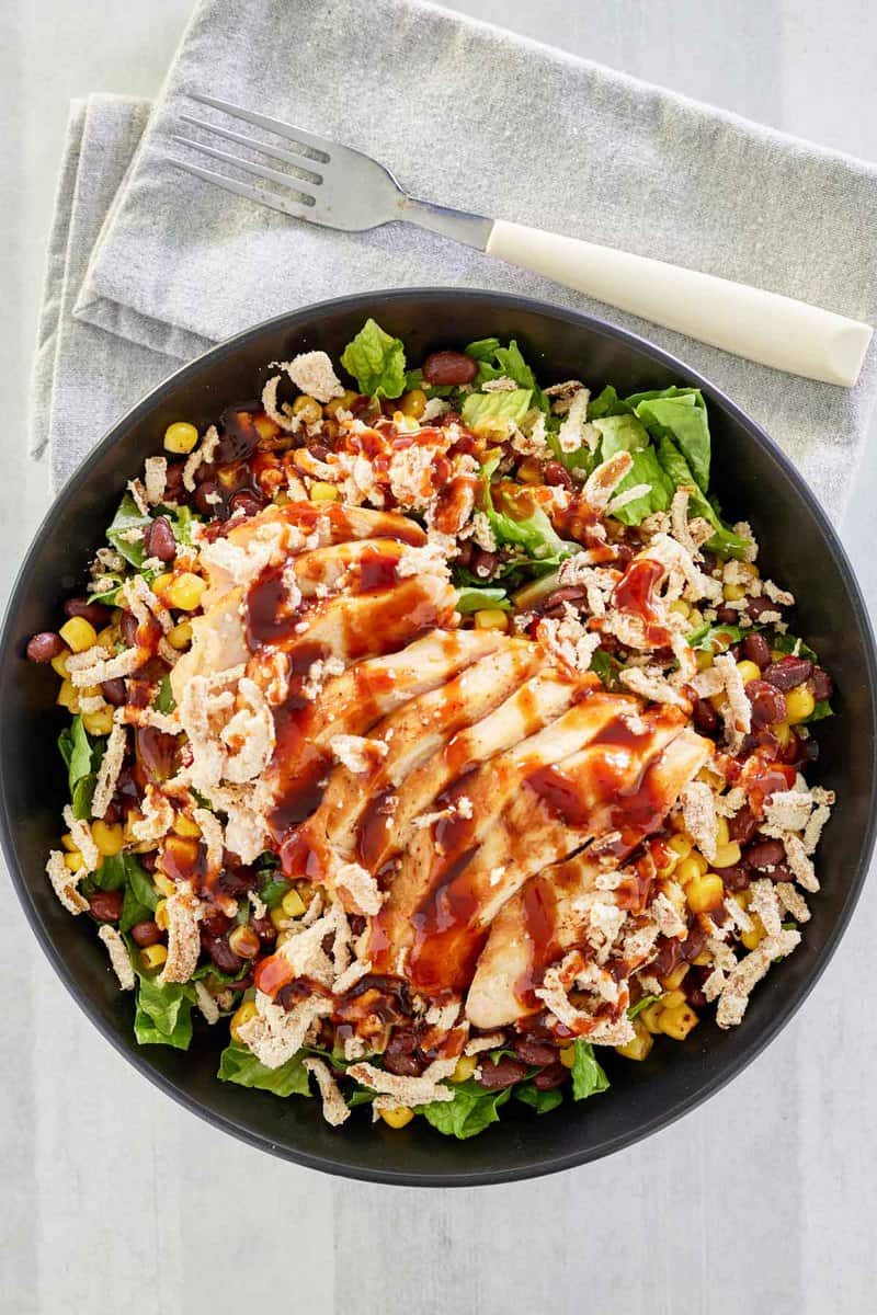 Overhead view of copycat Panera BBQ chicken salad and a fork on a napkin