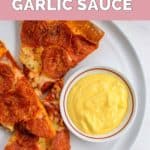 copycat Papa John's garlic sauce and pizza slices on a plate.