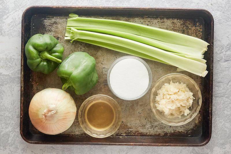 sauerkraut salad ingredients on a baking sheet.